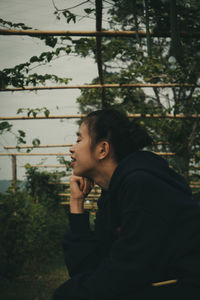 Portrait of young man against plants