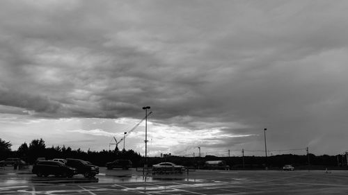 View of city street against cloudy sky