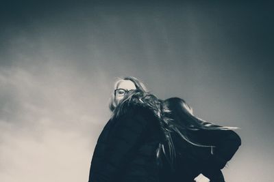 Portrait of woman against sky