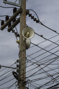 Low angle view of electricity pylon against sky