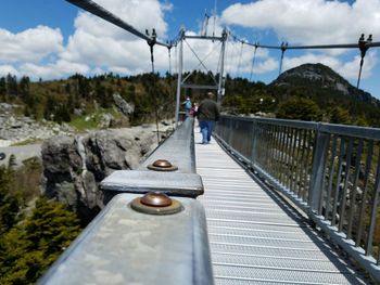 Bridge against cloudy sky