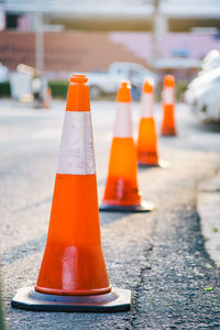 Close-up of orange flag on road in city