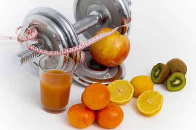 Fruits in glass container on white background