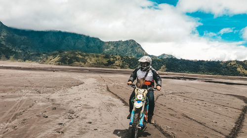 Man riding motorcycle on land