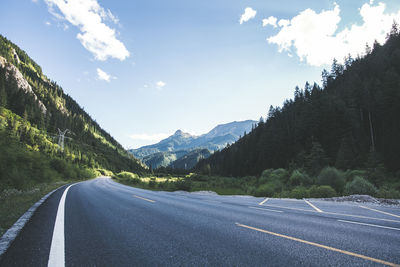 Road amidst mountains against sky