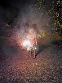 Boy holding sparkler at night