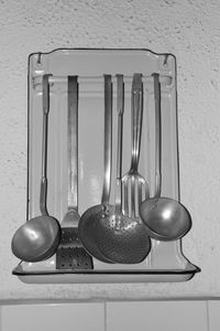 Close-up of utensils hanging in kitchen