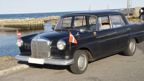 Vintage car on road by sea