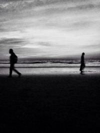 Silhouette people on beach