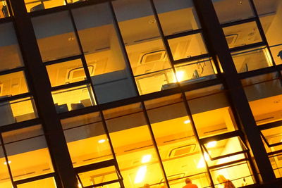 Low angle view of illuminated windows at sunset
