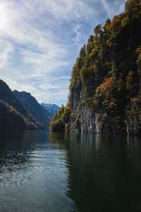 Scenic view of lake by trees against sky