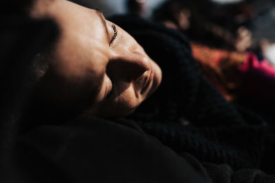 Low section of man lying on bed