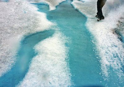 Low section of person on snow covered field