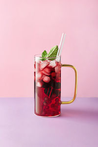 Close-up of drink in glass against white background