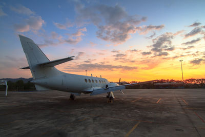 Airplane at airport during sunset