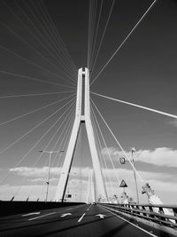 Low angle view of suspension bridge against sky