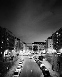 View of city street and buildings at night