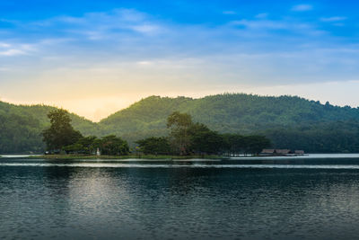 Scenic view of lake by trees against sky