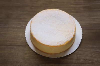 Cheesecake or german cheese cream tart on rustic wooden table