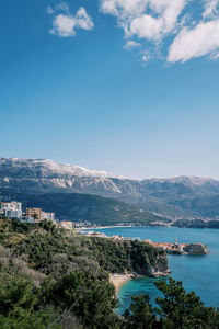 High angle view of townscape by sea against sky