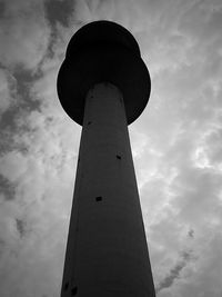 Low angle view of tower against cloudy sky