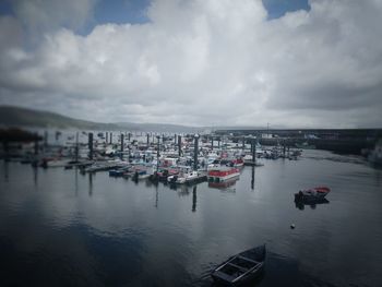 Boats moored in sea against sky