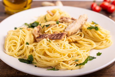 Spaghetti with mackerel served on white plate. meal rich in omega 3