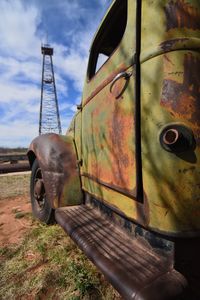 Close-up of abandoned train against sky