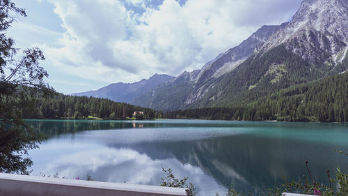 Scenic view of lake by mountains against sky