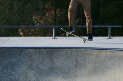 Low section of man skateboarding on skateboard