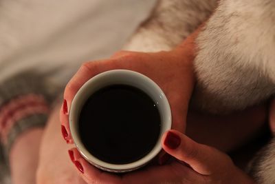 Close-up of hand holding coffee cup