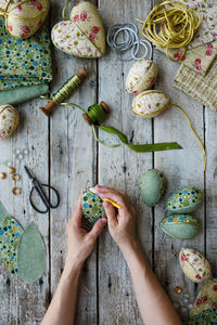 Cropped hand of woman holding food on table