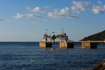 Bridge over sea against sky