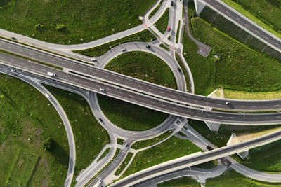 Cars moving on transport road junction in city, aerial view