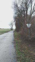 Empty road passing through field