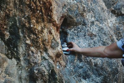 Midsection of person holding rock