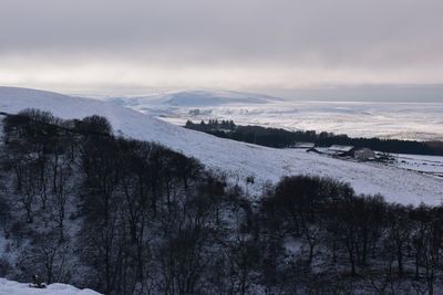 Scenic view of snow covered landscape against sky