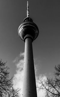 Low angle view of communications tower against sky