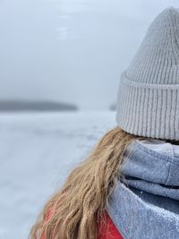 Rear view of woman in sea against sky