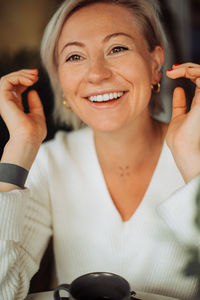 Close up of a blond woman with happy smile