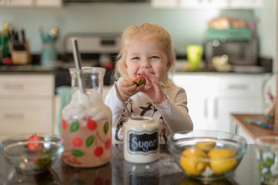 Cute girl having fruit at home