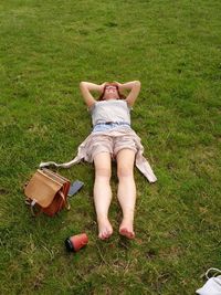 People relaxing on grassy field