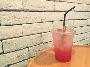 Close-up of red drink on brick wall