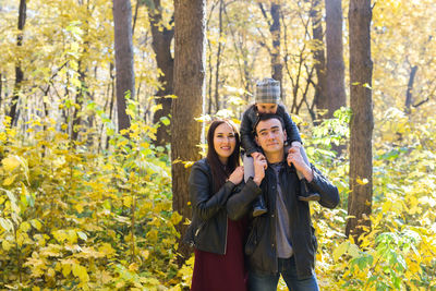 Portrait of couple standing in forest