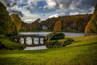 Arch bridge over river against sky