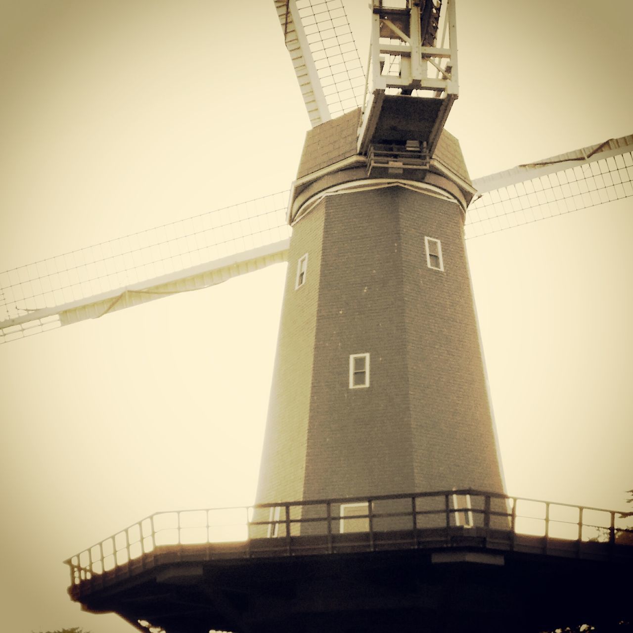 built structure, architecture, building exterior, low angle view, clear sky, tower, lighthouse, connection, safety, sky, guidance, protection, tall - high, copy space, security, outdoors, no people, industry, direction, day