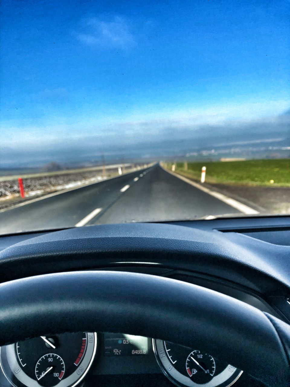 ROAD SEEN THROUGH WINDSHIELD OF CAR