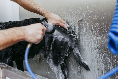 Midsection of man working in water