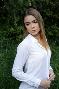 Beautiful young woman standing on grass