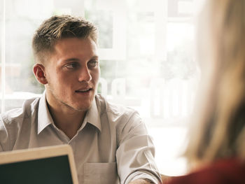 Businessman looking away while sitting in office